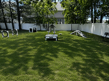 Lakewood apartment for rent - A backyard with a white fence and a dog house.