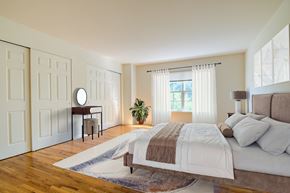 Lakewood apartment for rent - A bedroom with a large bed and a window with curtains.