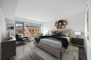 Yonkers apartment for rent - A bedroom with a large bed and a chair by the window.