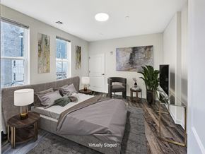 Bound Brook apartment for rent - A bedroom with a large bed and a chair.
