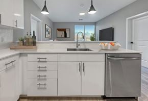 Orange apartment for rent - A modern kitchen with white cabinets and a stainless steel dishwasher.