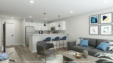 Orange apartment for rent - A modern living room with a grey sofa and a bar area.