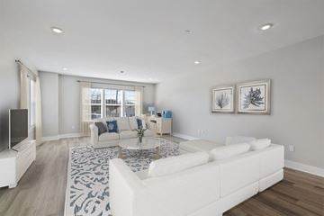 Poughkeepsie apartment for rent - A living room with a white couch and a television.