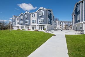 Poughkeepsie apartment for rent - A large building with a grassy area in front.