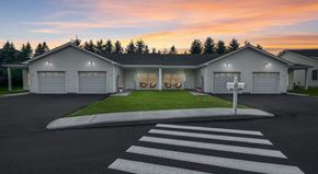 Pine Plains apartment for rent - A house with a white garage door is shown with a street in front of it.