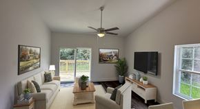 Pine Plains apartment for rent - A living room with a couch, a coffee table, a television, and a ceiling fan.