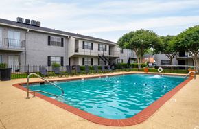 Bossier City apartment for rent - A swimming pool in front of apartment buildings.