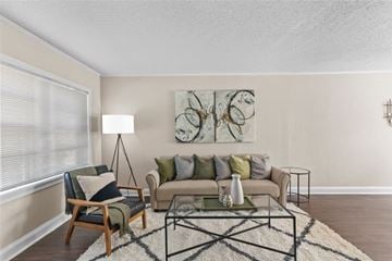 Shreveport apartment for rent - A living room with a couch, chair, and a painting on the wall.
