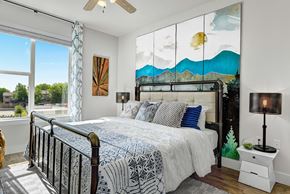 Austin apartment for rent - A bedroom with a large bed and a painting on the wall.