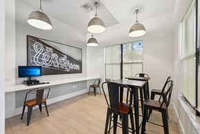 Miramar apartment for rent - A modern dining room with a chalkboard on the wall and a TV on the left side.