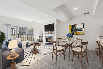 Dublin apartment for rent - A living room with a fireplace, a painting, and a dining table set up.
