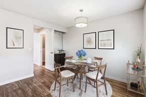 Cincinnati apartment for rent - A dining room with a table set for two and a chandelier hanging from the ceiling.