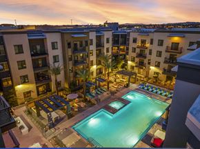 Scottsdale apartment for rent - A swimming pool in a courtyard surrounded by apartment buildings.