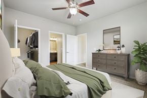Zionsville apartment for rent - A bedroom with a bed, dresser, and mirror.