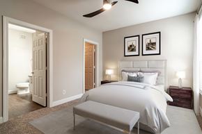 Atlanta apartment for rent - A bedroom with a large bed and a ceiling fan.