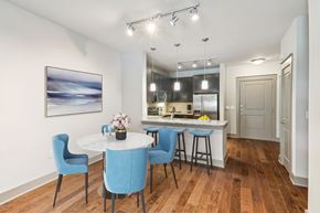 Charlotte apartment for rent - A dining room with a white table and blue chairs.