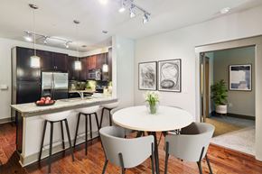 Charlotte apartment for rent - A kitchen with a table and chairs in the foreground.