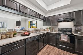 Dublin apartment for rent - A kitchen with black cabinets and a wood floor.