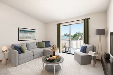 Moraine apartment for rent - A living room with a grey couch, a coffee table, and a painting on the wall.