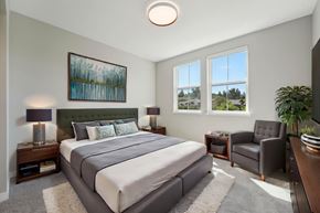 Santa Rosa apartment for rent - A bedroom with a large bed, a chair, and a painting on the wall.