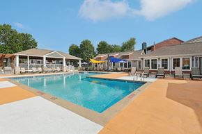Cincinnati apartment for rent - A large swimming pool with a yellow and white striped border.