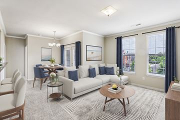 Zionsville apartment for rent - A living room with a white sofa, a coffee table, and a painting on the wall.