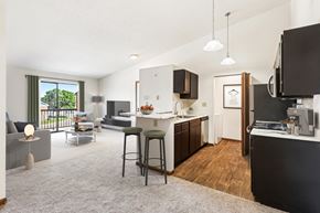 Moraine apartment for rent - A modern kitchen with dark wood cabinets and a white countertop.