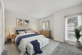 Dublin apartment for rent - A bedroom with a large bed and a plant.