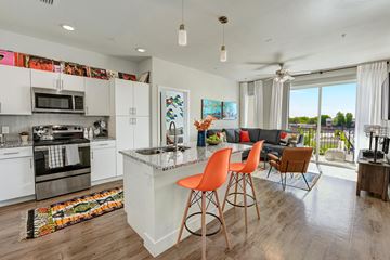 Austin apartment for rent - A modern kitchen with white cabinets and a large island.