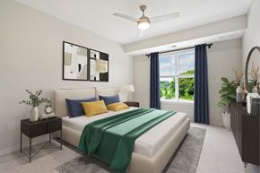 Burnsville apartment for rent - A bedroom with a bed, nightstand, and a ceiling fan.