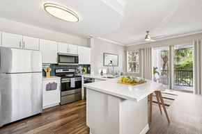 Coral Springs apartment for rent - A kitchen with a white island and stainless steel appliances.