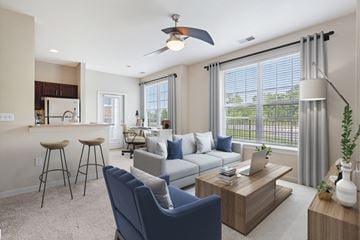 Miamisburg apartment for rent - A modern living room with a blue chair and a coffee table.