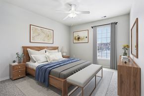 Carmel apartment for rent - A bedroom with a bed, nightstand, and a window with curtains.