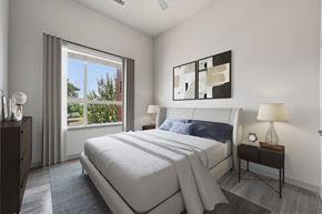 Denver apartment for rent - A bedroom with a large bed and a window with curtains.