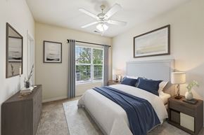 Columbus apartment for rent - A bedroom with a bed, nightstands, and pictures on the wall.