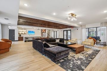 Burnsville apartment for rent - A modern living room with a black couch and wooden floors.