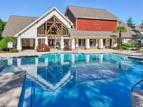 Charlotte apartment for rent - A large house with a pool in front.
