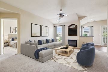 Miamisburg apartment for rent - A living room with a grey couch, a coffee table, and a fireplace.