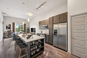 Denver apartment for rent - A modern kitchen with a dining table and chairs.