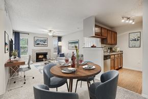 Cincinnati apartment for rent - A modern dining room with a table set for two and a fireplace.
