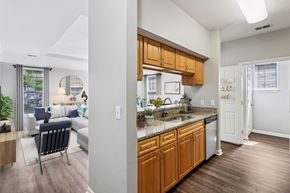 Carmel apartment for rent - A kitchen with wooden cabinets and a white refrigerator.