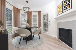 Frisco apartment for rent - A modern dining room with a black table and chairs.