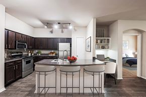 Irving apartment for rent - A kitchen with a bar stool in front of the island.
