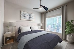 Irving apartment for rent - A bedroom with a large bed and a ceiling fan.