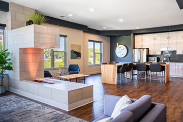 Blue Ash apartment for rent - A modern living room with a grey couch and a wooden coffee table.