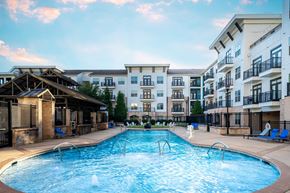 Cary apartment for rent - A large swimming pool in front of apartment buildings.
