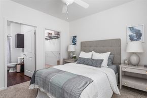 Indianapolis apartment for rent - A bedroom with a large bed and a ceiling fan.
