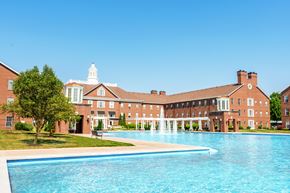 Carmel apartment for rent - A large building with a pool in front of it.