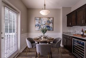 Carmel apartment for rent - A dining room with a table set for two and a painting on the wall.