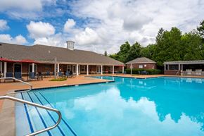 Murfreesboro apartment for rent - A large swimming pool with a metal ladder in the foreground.